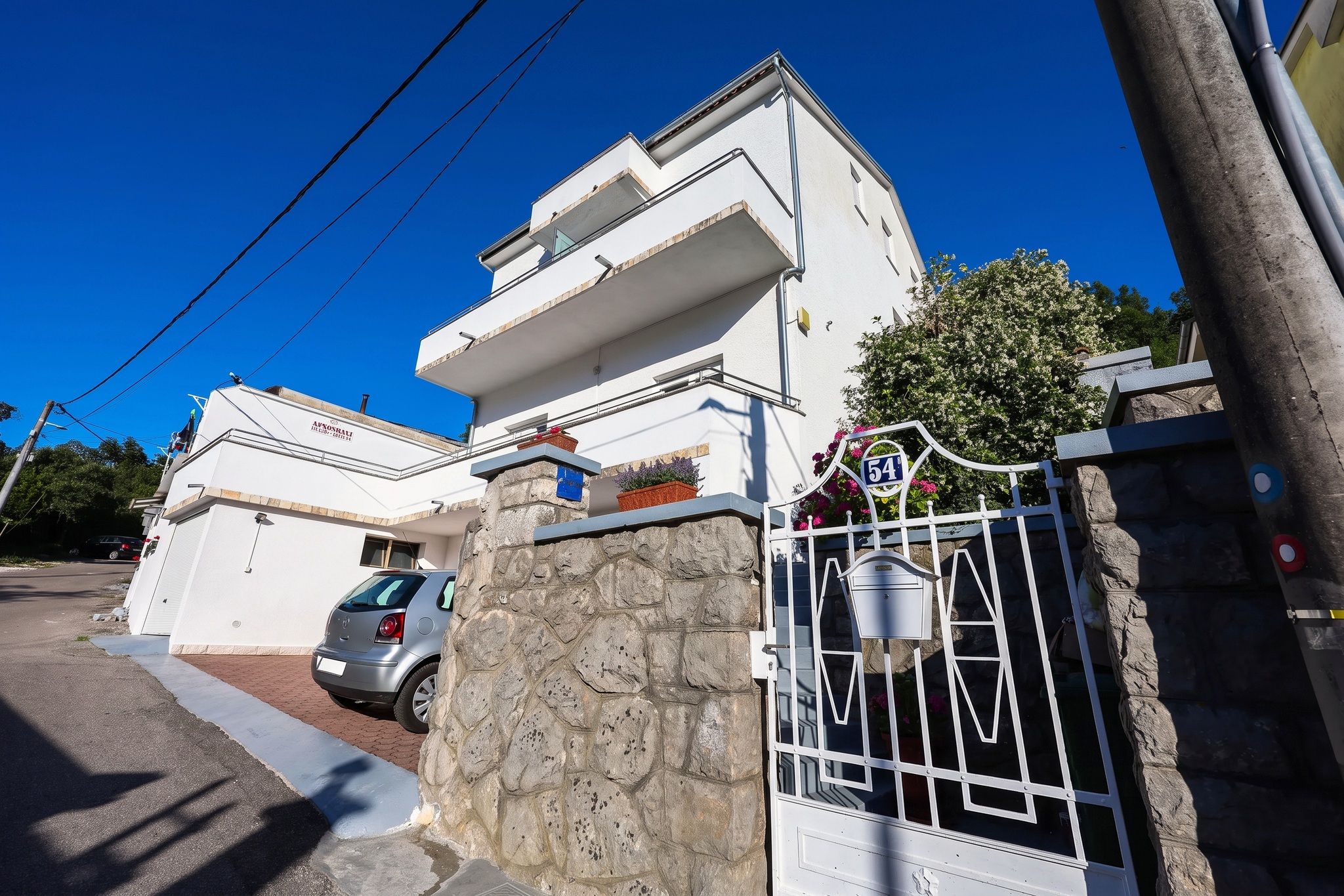 The house from the street, with a car in the parking space