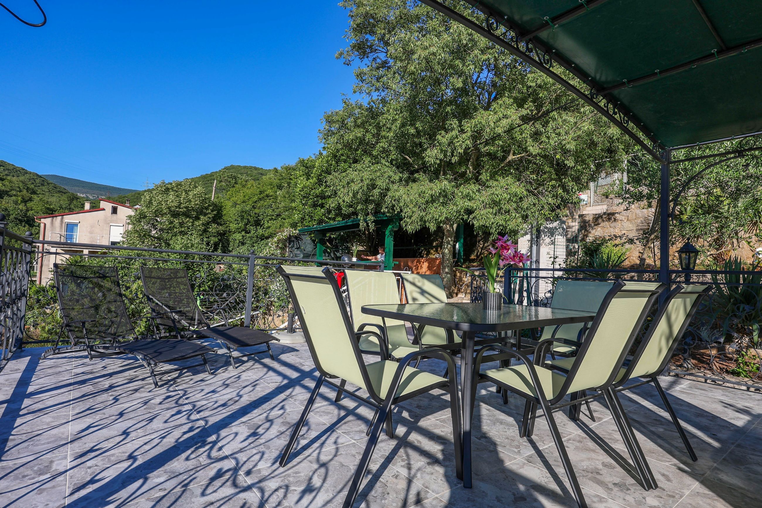 The roof terrace under its canopy, with the barbecue station beyond the railing